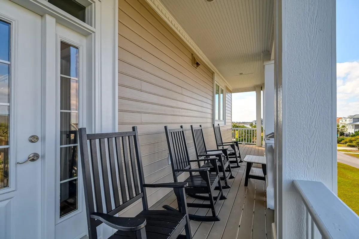 This tranquil exterior shot highlights rocking chairs on a porch with a scenic view beyond. The arrangement suggests a peaceful spot for morning chats, relaxation, or sharing stories—perfect for unwinding after a day spent exploring the local area.